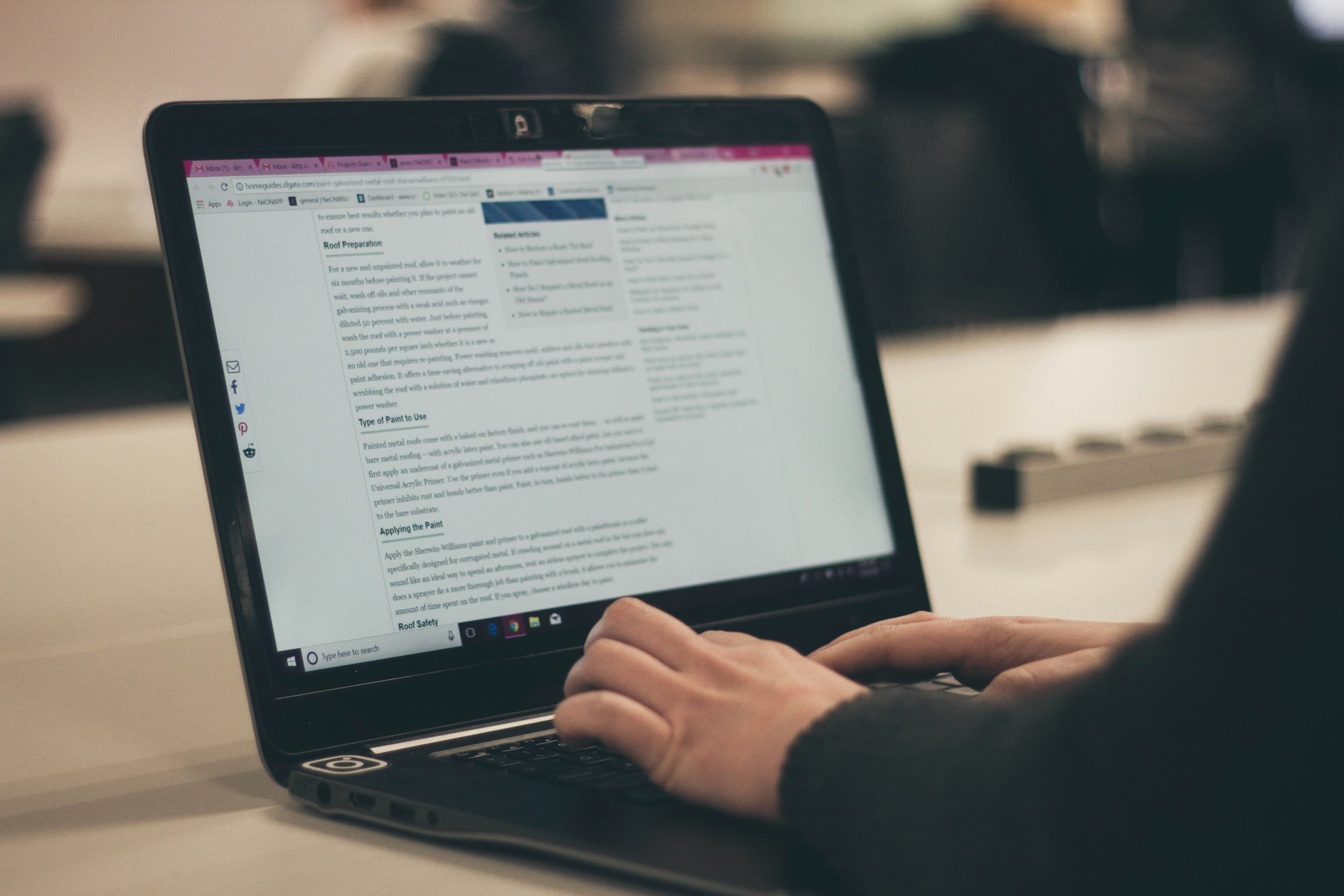 Writer drafting web content on a laptop
