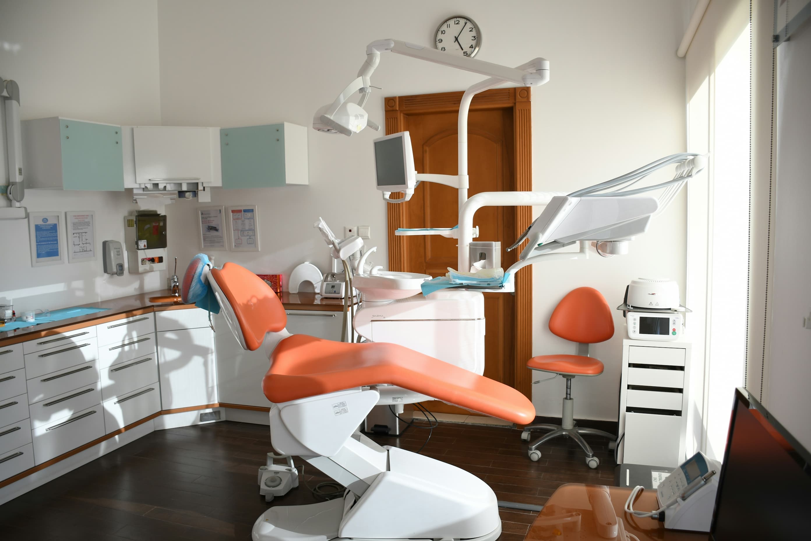 An empty dentist chair in a modern dental surgery